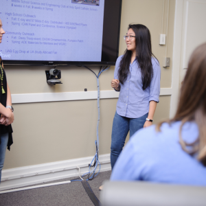 Tatum Martin and Lauren Pan, both UA SWE officers, read through a presentation of the organization’s facts and figures from the previous school year, which was given to the UA SWE Alumni Board.