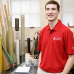peyton strickland in a red shirt in a rocketry workshop area