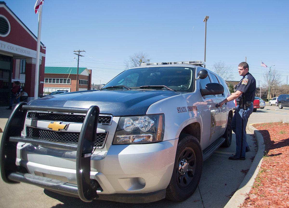 a policeman outside his car