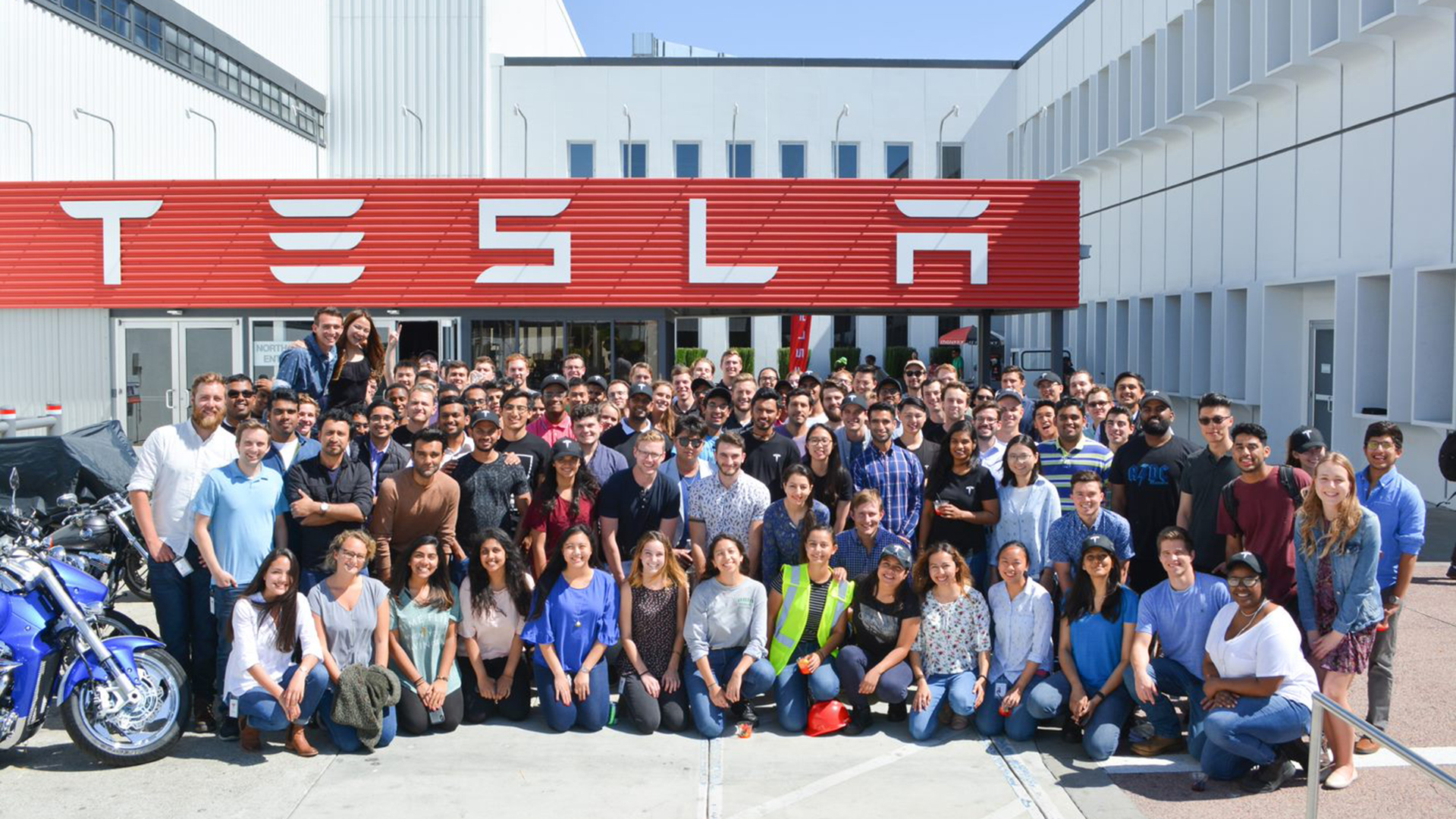 huge group photo outside the Tesla building