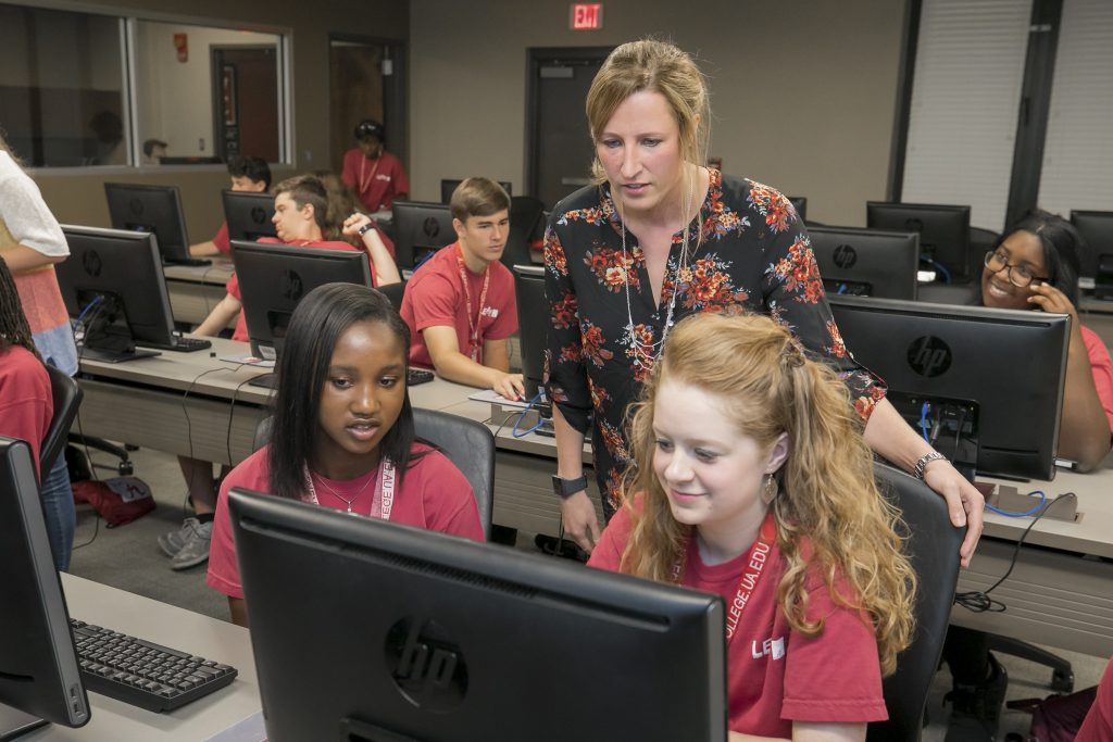 UA students help kids in a computer lab