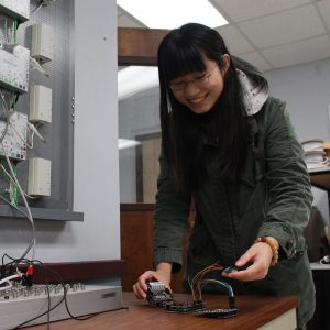 A student works with wireless board in a lab on campus