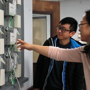 A professor and student work in a lab