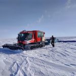 A machine plowing through snow