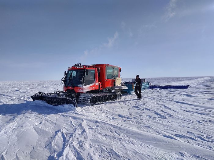 A machine plowing through snow