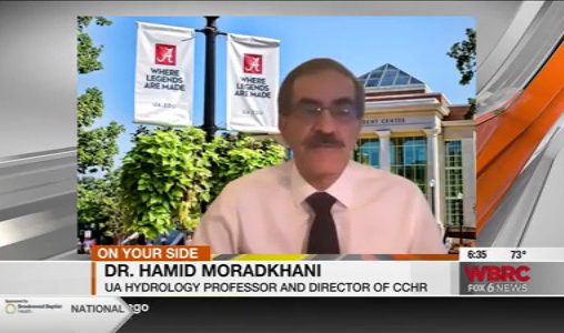 News screen capture of Dr. Moradkhani with a zoom background showing the Ferg Center
