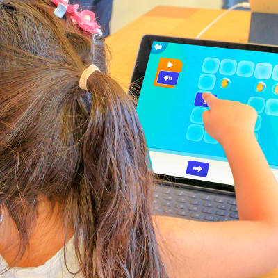 Tinker app- a child touching an ipad screen