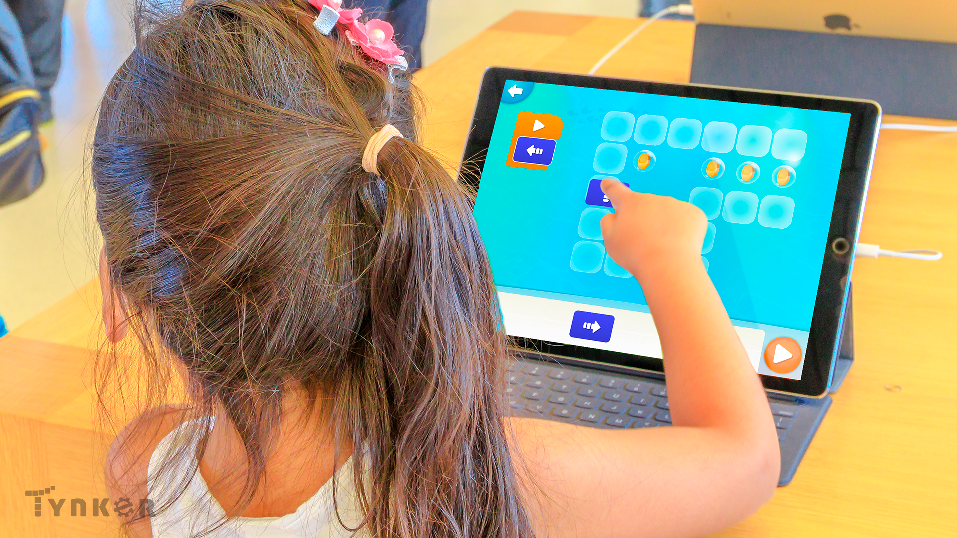 Tinker app- a child touching an ipad screen