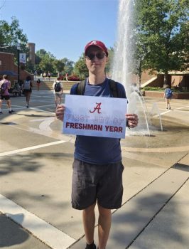 Patrick Bartoszewicz holding a first day at UA sign
