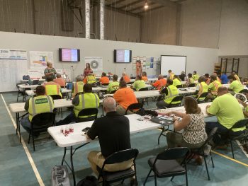 People wearing high visibility safety vests at a training session
