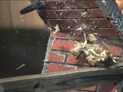 a brick wall being busted up by high speed wood
