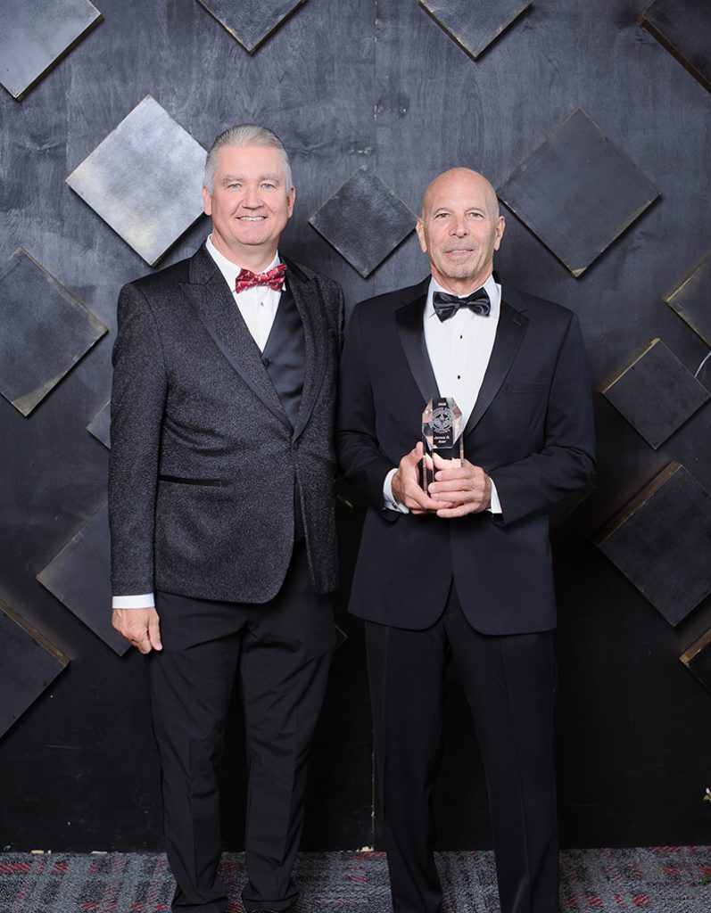 Dean and bald man in black bowetie