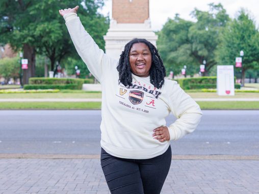 A student cheering in front of Denny Chimes