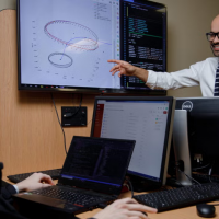 Professor pointing at a whiteboard