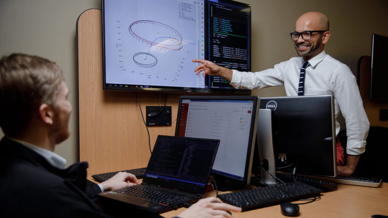 Professor pointing at a whiteboard