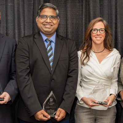 Dr. Patrick A. Frantom, Dr. Sriram Aaleti, Dr. Heather Ashley Hayes and Dr. Kagendo Mutua pose with glass awards.