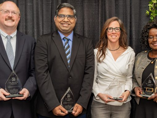 Dr. Patrick A. Frantom, Dr. Sriram Aaleti, Dr. Heather Ashley Hayes and Dr. Kagendo Mutua pose with glass awards.