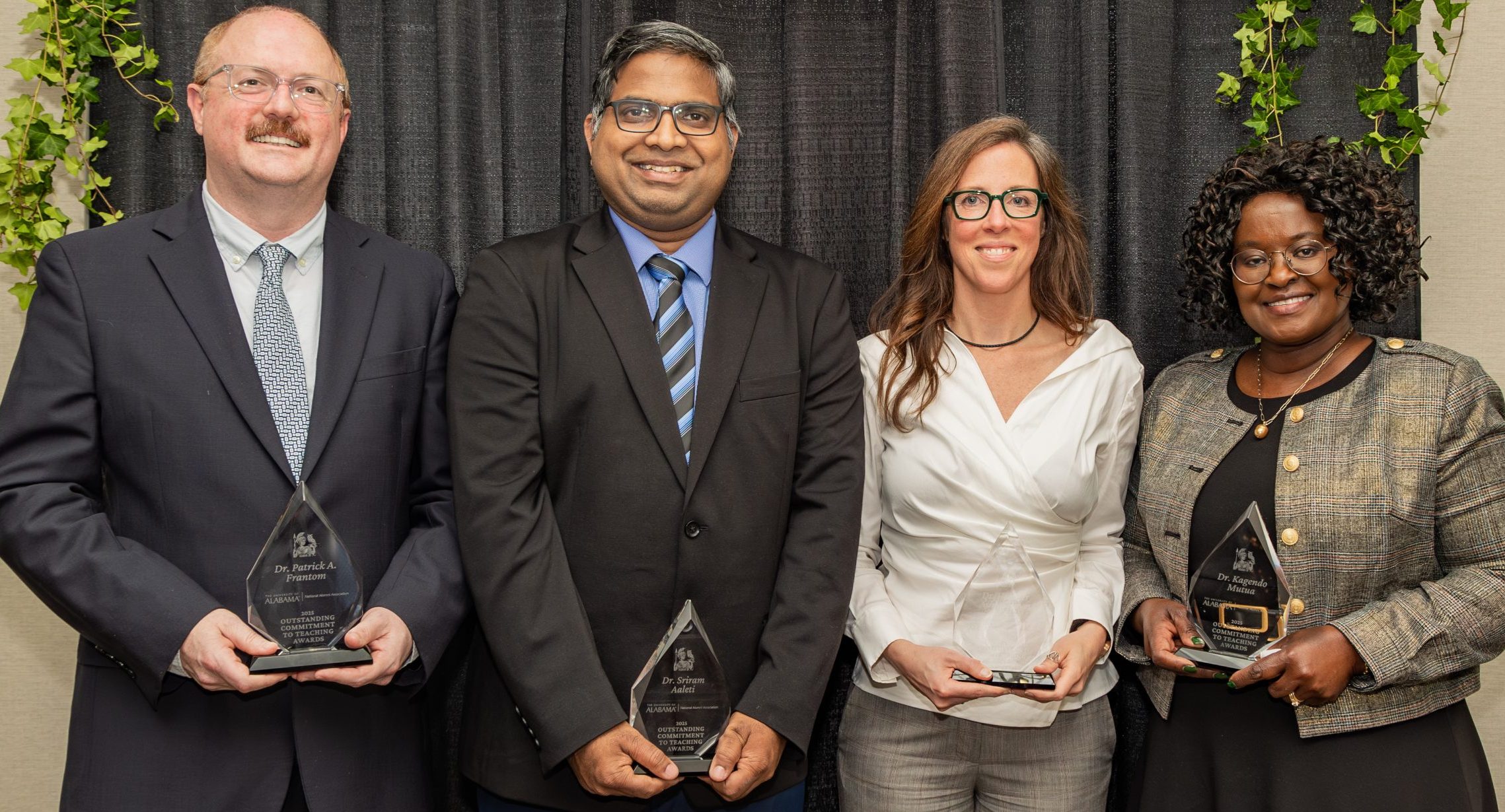 Dr. Patrick A. Frantom, Dr. Sriram Aaleti, Dr. Heather Ashley Hayes and Dr. Kagendo Mutua pose with glass awards.