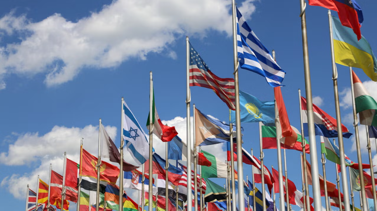 bunch of country flags waving in the air