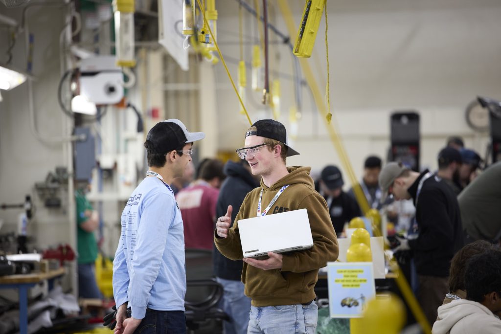 2 students talking in a large crowded area
